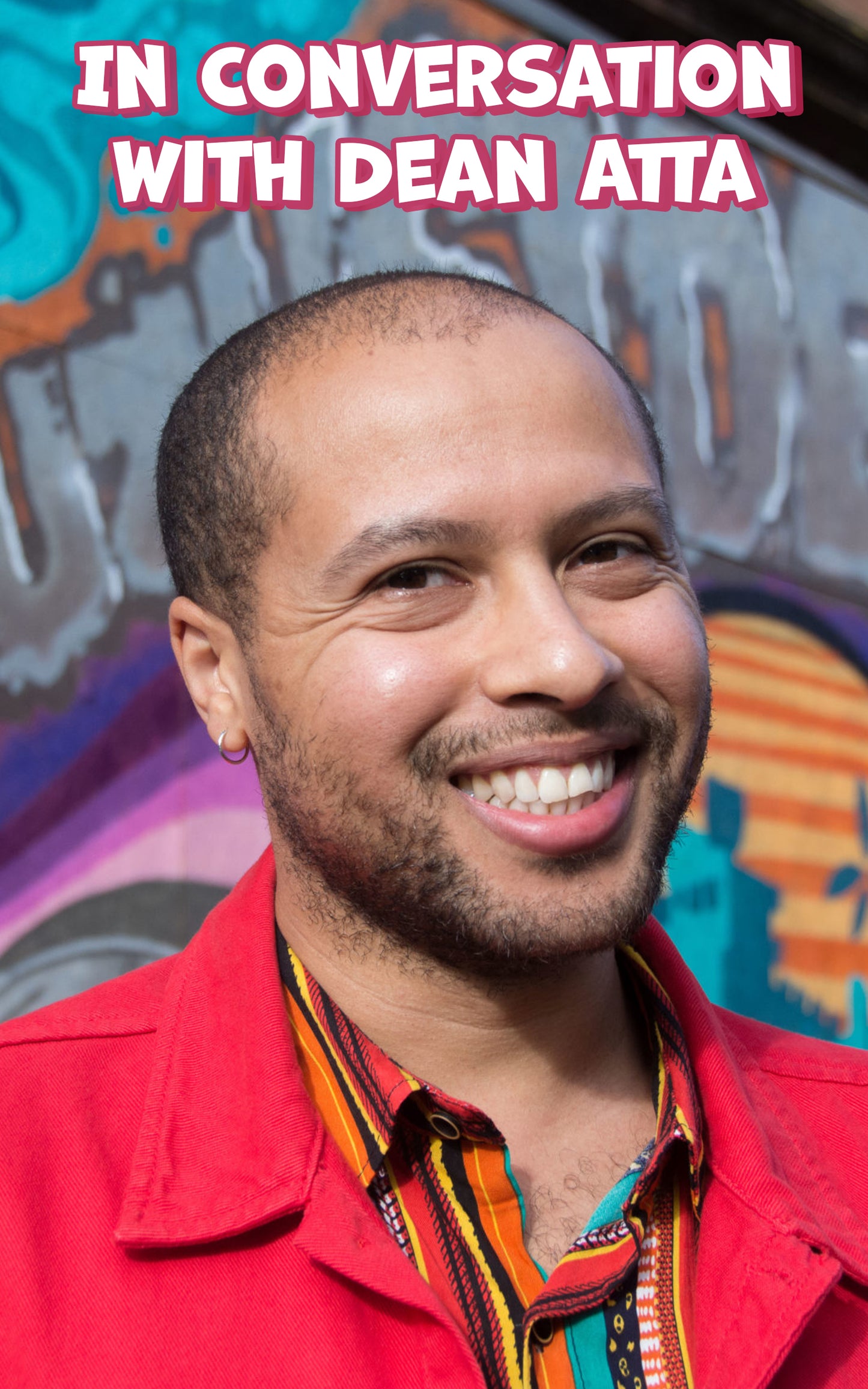 Dean Atta, a black man with short black hair, smiles at the camera cheerily while wearing a colourful shirt and red jacket. Above him is white text that reads "In Conversation with Dean Atta."