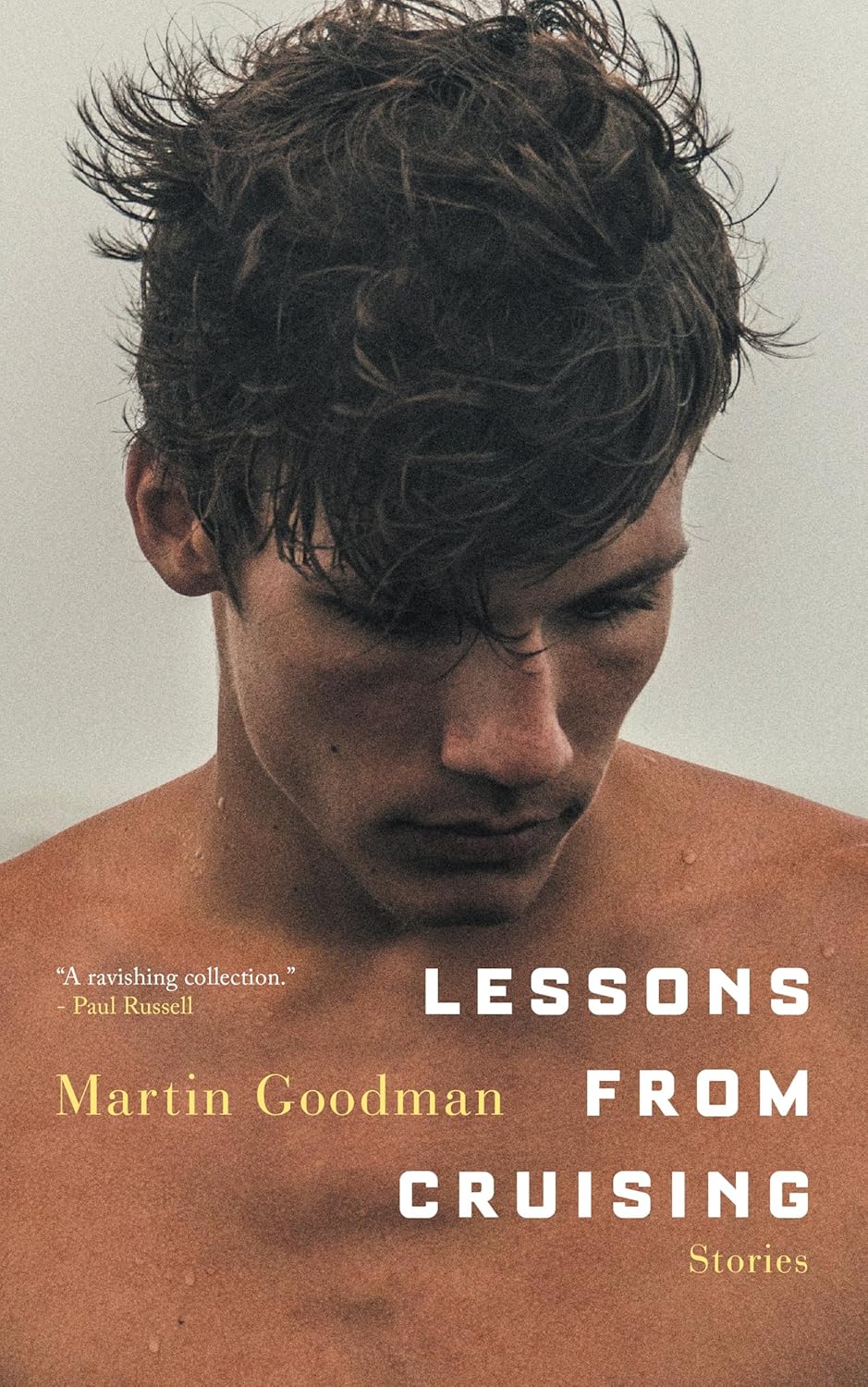 The cover for Lessons from Cruising shows the head a shoulders of a white man. He is wearing no clothes and there are water droplets on his neck and shoulders. His face is looking down so the top of his head is the main thing seen. The title of the book is written in white text which is overlayed on his chest. Other text includes the authors name and a quote about the boook.