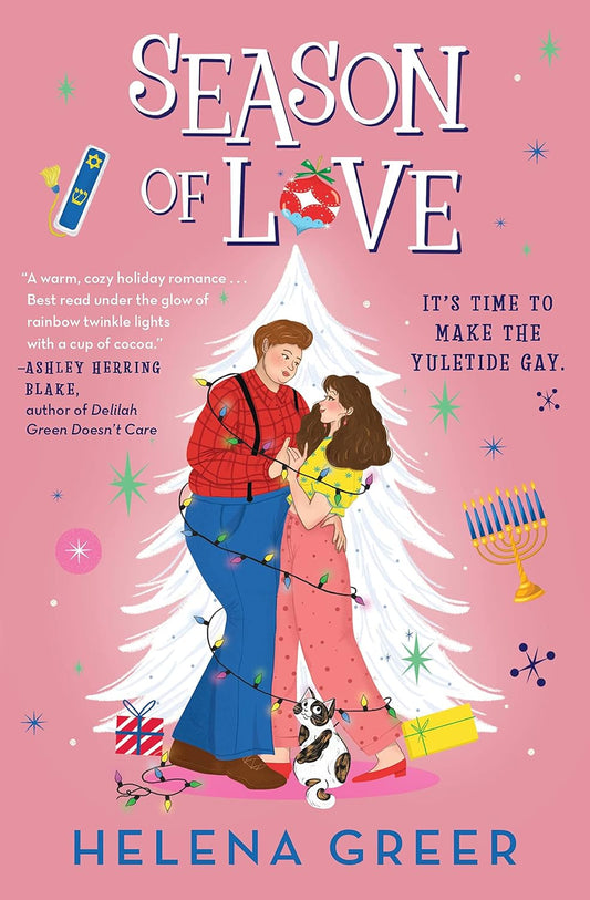 The cover of Season of Love is pink. In the centre is a white Christmas tree and in front of it is two people, embracing and wrapped in Christmas tree lights. One has short brown hair and is wearing a red checked shirt, blue trousers, suspenders and brown shoes. The other has long brown hair and is wearing a yellow t-shirt with blue stars, pink trousers with darker pink dots and red shoes. At their feet is a brown and white cat. Around them is a menorah with blue candles and some stars.